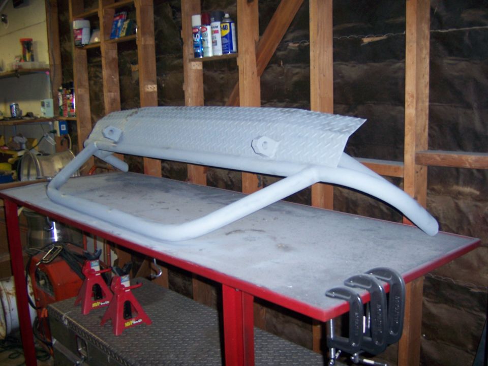 Custom front bumper with diamond plate top and tubular supports