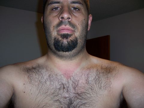 1991 Ford Bronco - Close-up of a man's face and chest, showing facial hair and a red mark on his neck.