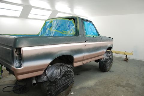 1996 Ford Bronco - Ford Bronco in paint booth, windows taped off, ready for paint work.