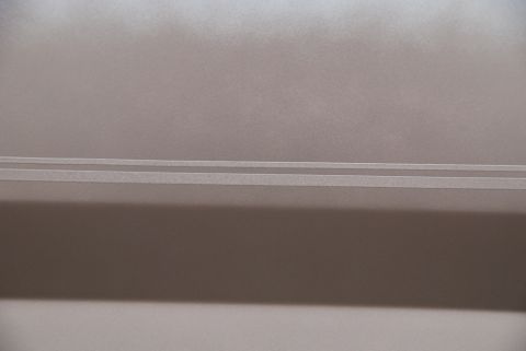 1996 Ford Bronco - A detail shot focuses on the horizontal body lines and texture of a vehicle's side panel.