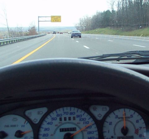 1998 Ford Taurus - Driving on the highway with a view of the dashboard and other vehicles.