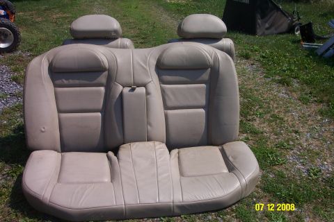 1992 Ford Bronco - Car seats are displayed outdoors on grass, with a lawnmower in the background.