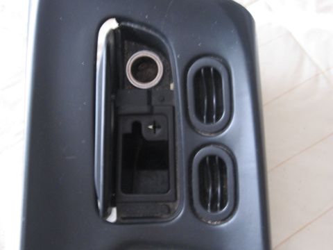 1995 Ford Thunderbird - Close-up of a car's interior part, showing air vents and a compartment.