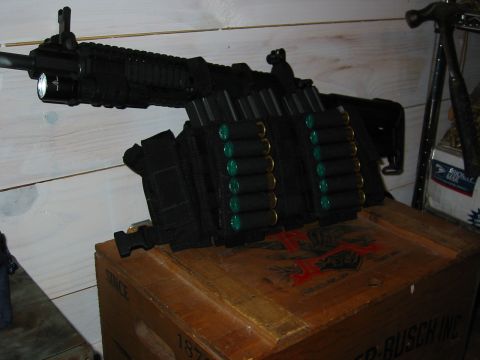 1996 Ford Bronco - A shotgun with an attached ammo belt and tactical flashlight rests on a wooden crate.