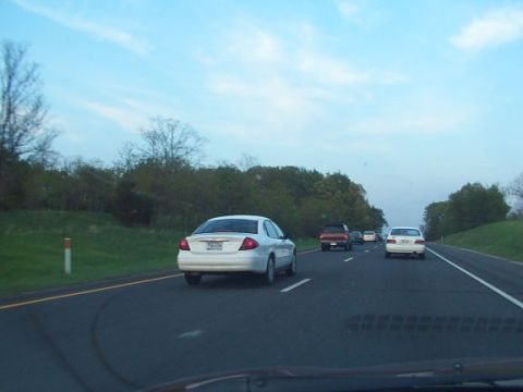 1998 Ford Taurus - Driving on the highway behind a white 1998 Ford Taurus sedan.