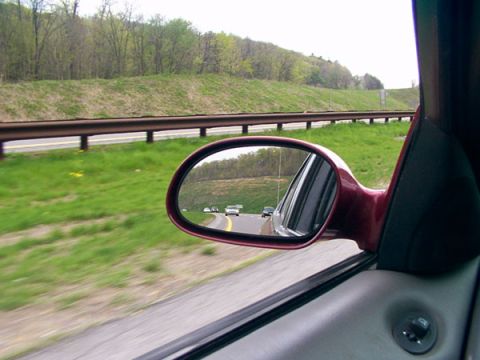 1998 Ford Taurus - Other vehicles are visible on the road ahead, reflected in the side mirror.