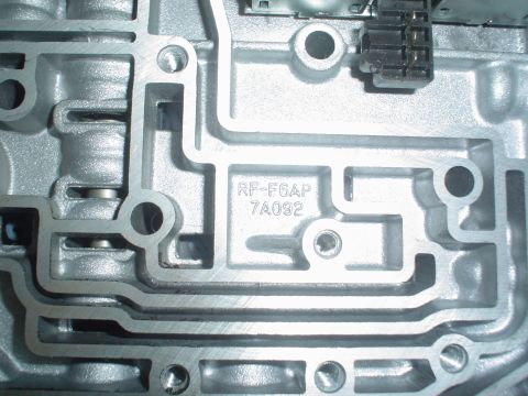1996 Mercury Grand Marquis - Close-up of a metal component, likely from a vehicle's transmission, showing stamped identification codes.