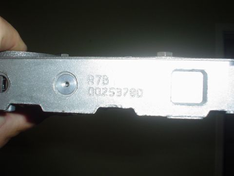 1996 Mercury Grand Marquis - A metal component is held, showing stamped identification numbers.