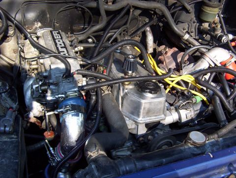1986 Toyota Hilux - Close-up of an engine bay a turbocharger and various engine components.