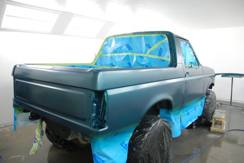 1996 Ford Bronco - This 1996 Ford Bronco is in a paint booth, with windows and trim taped off in preparation for a new coat of paint.