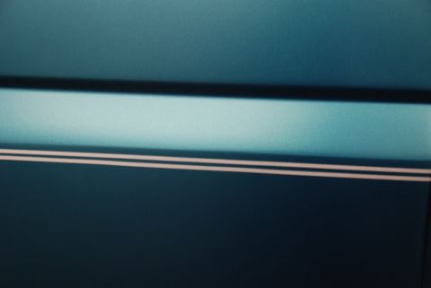 1996 Ford Bronco - Close-up of a car's side panel shows a two-tone paint scheme with pinstriping.