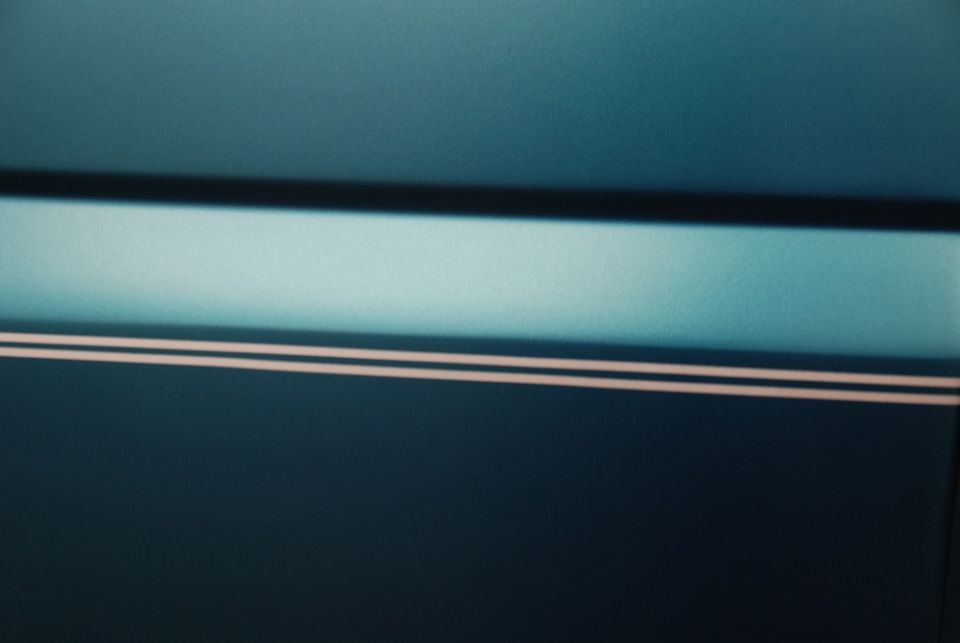 Dark teal car door with a light teal stripe and two thin white pinstripes