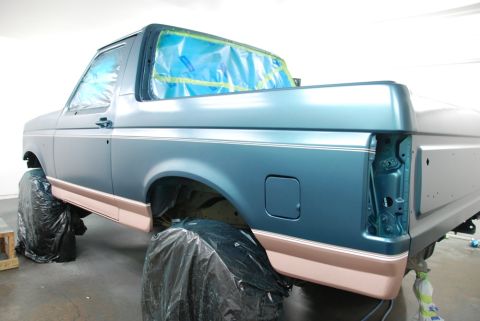 1996 Ford Bronco - Ford Bronco body undergoing a paint job, with windows covered in protective plastic sheeting.