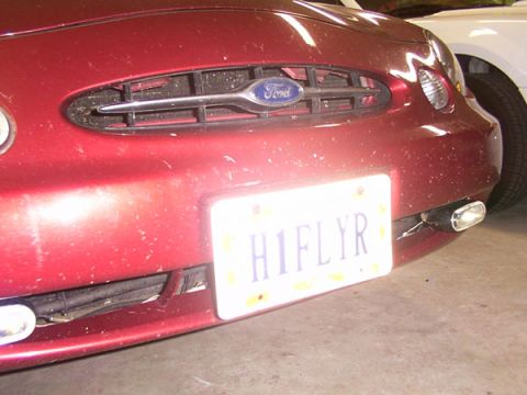 1998 Ford Taurus - Front view of a red 1998 Ford Taurus, showing the grille and license plate.