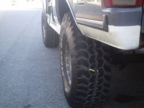 1991 Ford Bronco - Close-up of the rear wheel and fender of a 1991 Ford Bronco.