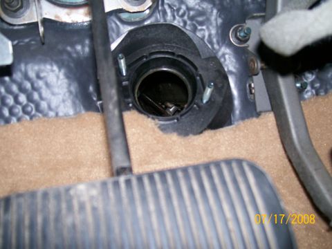 1995 Mercury Grand Marquis - Close-up of an empty round shifter mounting opening in a carpeted vehicle floor next to a rubber pedal, timestamped Jan 17 2008.