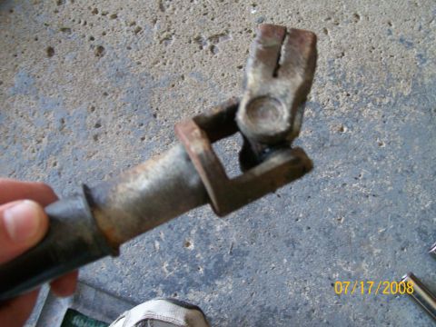 1995 Mercury Grand Marquis - Rusty steering shaft U-joint, likely from an older vehicle.