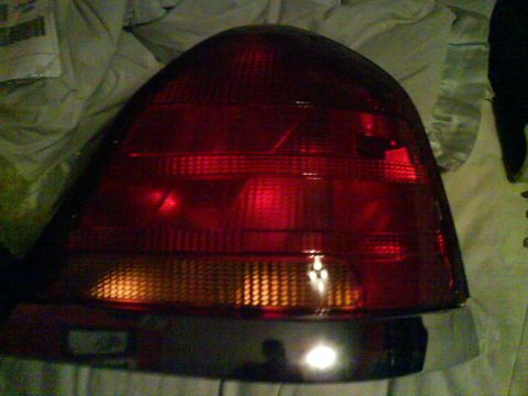 2003 Ford Crown Victoria - This is a close-up view of a vehicle's red taillight assembly, which includes an amber section for the turn signal.