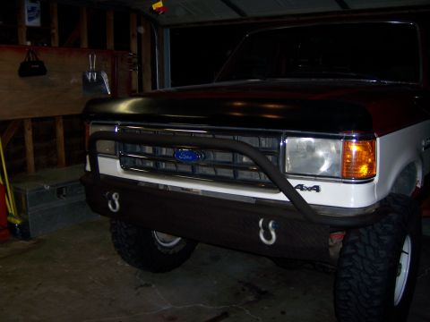 1991 Ford Bronco - Front view of a 1991 Ford Bronco showing the grille and custom bumper with 4x4 badging.