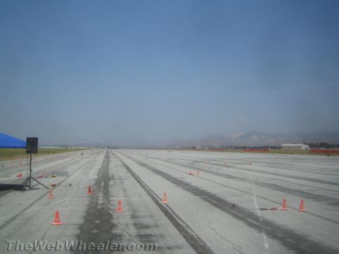 1985 Ford Mustang - Autocross event setup on a paved track with cones marking the course.