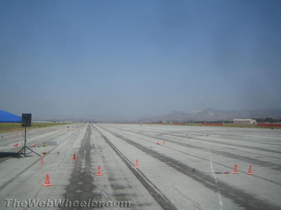 Racetrack with orange cones and a blue tent on the left
