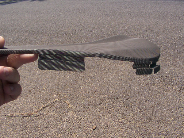 Carbon fiber trim piece held by a hand