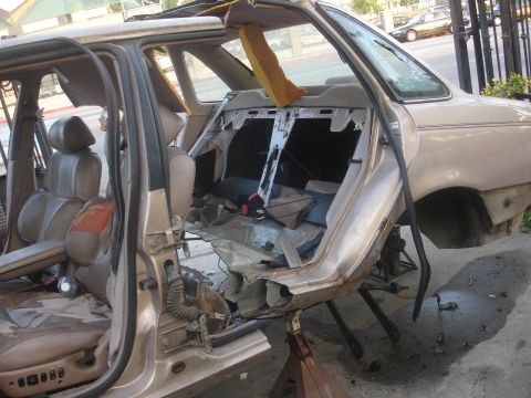 1991 Ford Taurus - The rear passenger side of a 1991 Ford Taurus has been removed, revealing extensive damage to the interior and exterior structure.