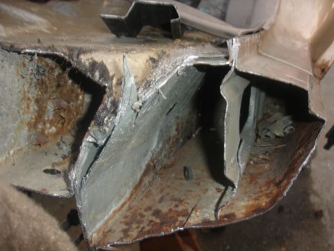 1991 Ford Taurus - Close-up view of severely damaged and rusted metal components, indicating significant structural compromise.