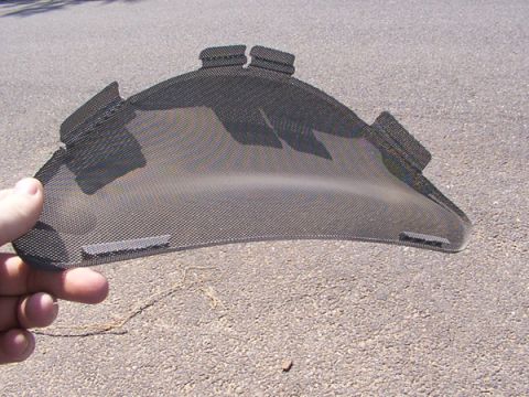 1998 Ford Taurus - Black mesh grille insert with mounting tabs held by hand.
