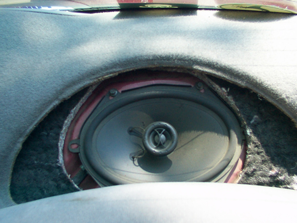 6x9 coaxial car speaker exposed in a rear deck with the grille cut away