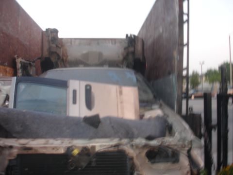 1991 Ford Taurus - Multiple wrecked vehicles are piled up, with a focus on the interior of a damaged van.