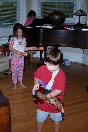 2000 Ford Crown Victoria - Children are playing in a room with a grand piano and toys.