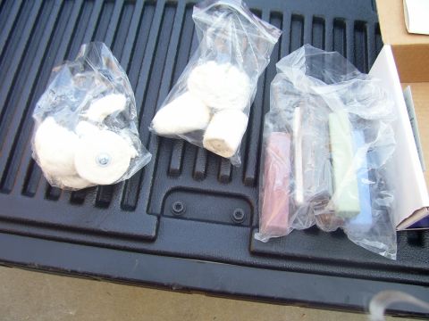 1979 Chevrolet Camaro - Polishing wheels and compound bars are packaged in plastic bags and placed on a dark textured surface.