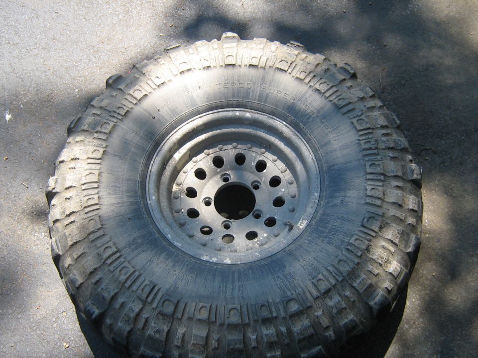 Off-road tire with aggressive tread and a multi-hole wheel