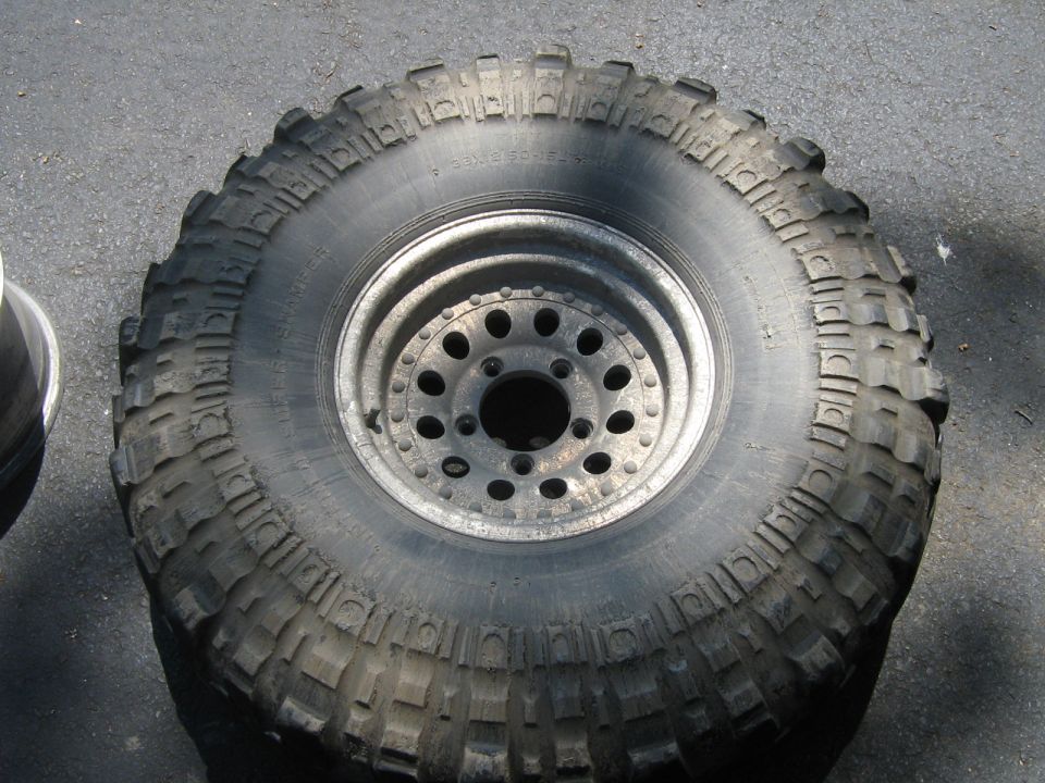 Off-road tire with aggressive tread mounted on a multi-hole wheel