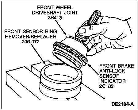 1998 Ford Taurus - Diagram illustrates the removal and replacement of a front sensor ring using specialized tools and a driveshaft joint.