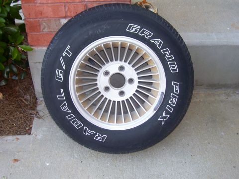 1979 Chevrolet Camaro - A single tire and rim assembly is shown resting on a concrete surface.