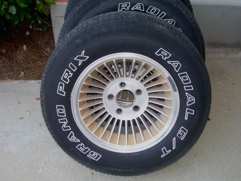 1979 Chevrolet Camaro - Set of four tires with "Grand Prix Radial G/T" lettering on the sidewalls and a distinctive multi-spoke wheel design.