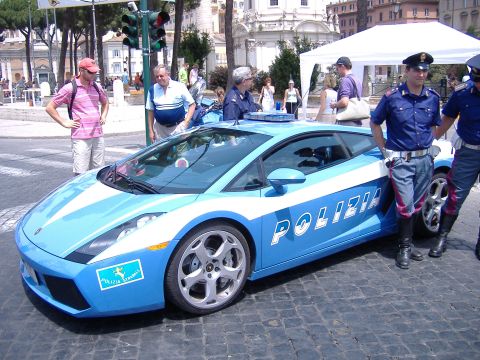 1993 Ford Taurus - An Italian police car, a Lamborghini, is parked on a cobblestone street with officers nearby.
