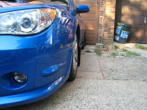 2007 Subaru Impreza - Front view of a blue 2007 Subaru Impreza, showing the headlight and bumper details.