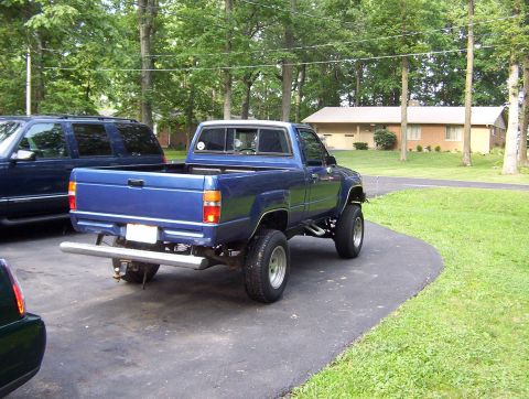 1986 Toyota Hilux - Rear view of a blue 1986 Toyota Hilux pickup truck with lifted suspension.