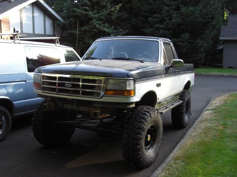 1993 Ford Bronco - This modified 1993 Ford Bronco features a two-tone paint scheme and significant lift with oversized tires.
