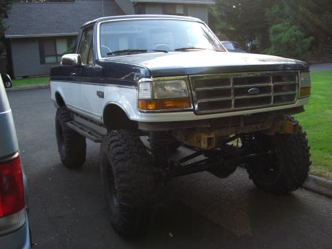 1993 Ford Bronco - This lifted 1992 Ford F-Series truck has a two-tone paint scheme and large off-road tires.