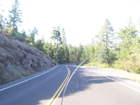 1994 Ford F-150 - Driving on a scenic road surrounded by trees and a rocky hillside.