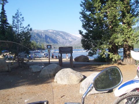 1994 Ford F-150 - A scenic view of a lake with boats docked and mountains in the distance under a clear blue sky.