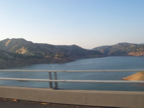 1994 Ford F-150 - A wide view of a body of water surrounded by hills, seen from a bridge.