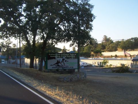 1994 Ford F-150 - A white van is parked in front of a building, with a sign advertising the Calaveras County Fair & Jumping Frog Jubilee.