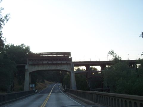 1994 Ford F-150 - View from a vehicle driving on a road passing under two different bridges.