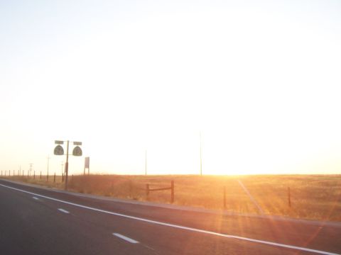 1994 Ford F-150 - A roadside scene with route signs and a bright sunset over a field.