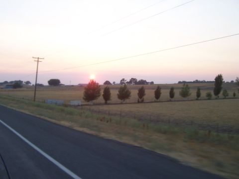 1994 Ford F-150 - A quiet roadside view captures the fading light of sunset over a rural landscape.